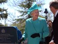 Queen Elizabeth II smiles at Saskatchewan Premier Lorne Calvert after unveiling a plaque officially opening the Centennial Project addition Government House Heritage Property in Regina, May 20, 2005.