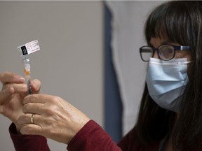 Heather Witzel-Garnhum, nurse clinician, prepares a syringe with the Pfizer-BioNTech COVID-19 vaccine at the Regina General Hospital in Regina on Tuesday Dec. 15, 2020.