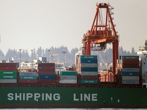 A container ship is unloaded at the DP World container terminal at Vancouver on Saturday, March 21, 2020.