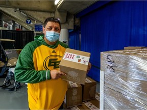 Tribal Chief Mark Arcand of the Saskatoon Tribal Council (STC) holds a care box containing soap, hand sanitizer and masks at the COVID-19 vaccine clinic in SaskTel Centre on April 9, 2021.