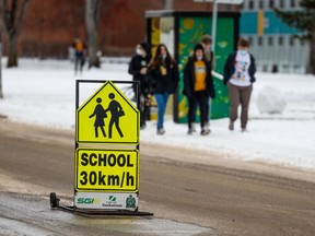 A school zone sign shows the speed limit is 30 km/h. Photo taken in Saskatoon, SK on Monday, November 22, 2021.