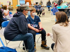 In photos provided by the Saskatchewan Health Authority, children five to 11 years old getting the COVID-19 vaccine at the Regina clinic.