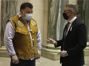Devin Bernatchez, left, band councillor at Sucker River, speaks with Everett Hindley, minister of mental health and addictions, seniors and rural and remote health, at the Legislative Building on Monday, Dec. 6, 2021 in Regina.