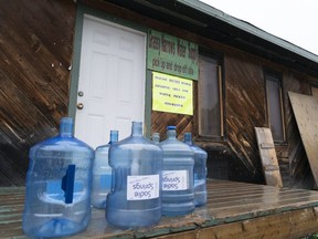 Water bottles are seen at the local water supply site on the Grassy Narrows First Nation, in northwestern Ontario, Saturday, Oct. 5, 2019. The Indigenous community has suffered six decades of the effects of a mercury contamination in the English-Wabigoon River. THE CANADIAN PRESS/Paul Chiasson
