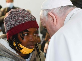 Pope Francis looking at a child during a meeting with refugees at the Reception and Identification Centre in Mytilene on the island of Lesbos.