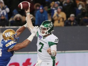 Roughriders quarterback Cody Fajardo throws a pass under pressure during Sunday's CFL West Division final against the host Winnipeg Blue Bombers.