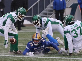Winnipeg Blue Bombers WR Drew Wolitarsky (centre) loses the football near the Saskatchewan Roughriders' end zone in the CFL West Final in Winnipeg. It was one of six turnovers the Riders forced in the first half.