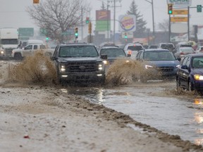 SASKATOON, SK-- Drivers navigate muddy water that covers Circle Drive after a water main break in Saskatoon, SK on Thursday, January 13, 2022.