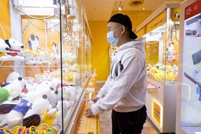 Edison Chen, owner of Catch Panda plays a claw machine in his Midtown Plaza location.