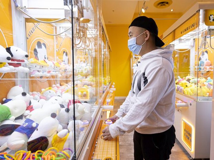  Edison Chen, owner of Catch Panda plays a claw machine in his Midtown Plaza location.
