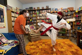 Kirtis Crowe and revered Mark Kleiner karate cut VHS tapes at the Nutflakes video rental store in the basement of Christ Church Anglican in Caswell Hill.