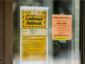 A sign declaring a COVID-19 outbreak hangs on the door of a Saskatoon long-term care home in this photo taken in Saskatoon, SK on Friday, November 27, 2020.