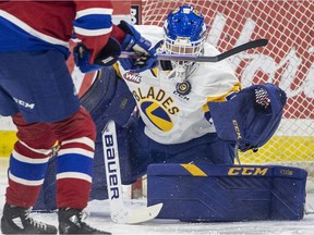 Saskatoon Blades goalie Nolan Maier (73) stops a shot from Edmonton Oil Kings forward Carter Souch (44) during first period WHL action in Saskatoon on Saturday, January 1, 2022.