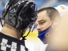 Saskatoon Blades head coach Brennan Sonne speaks with a referee during WHL action against the Edmonton Oil Kings in Saskatoon on Saturday, January 1, 2022.