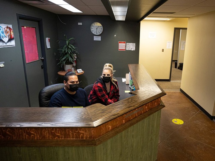  STC Wellness Centre employees Lanny Mcdonald and Krista Reid get to work at the front desk at 145 First Avenue North in Saskatoon on Wednesday, Jan. 12, 2022.