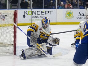 Saskatoon Blades goalie Ethan Chadwick (33) deflects a shot during first period WHL action against the Medicine Hat Tigers in Saskatoon on Friday, January 21, 2022.
