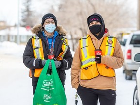 Delano Kennedy, left, and Sharise Nicotine of the Okihtcitawak Patrol Group (OPG) carry a bag of winter gear donated by Chokecherry Studios. OPG is one of many frontline groups noticing an increased rate of frostbite out on the streets due to a shortage of winter gear and limited shelter space.