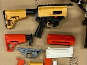 Several firearms and firearm parts, including 3D printed components, seized by Saskatoon Police. A 46-year-old man has been arrested for manufacturing restricted firearms.
