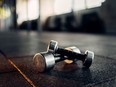 Dumbbells on rubber floor closeup view, fitness club, blur background
