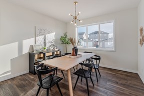 The spacious dining area in the Felix model home easily accommodates a large communal table. The sunny, versatile space overlooks the backyard patio. SUPPLIED PHOTO