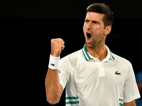 This file photo taken on February 18, 2021 shows Serbia's Novak Djokovic reacting after a point against Russia's Aslan Karatsev during their men's singles semi-final match on day 11 of the Australian Open tennis tournament in Melbourne.
