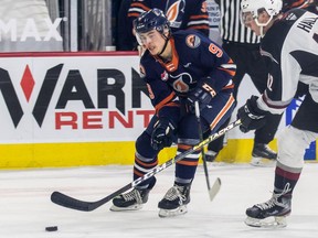 VANCOUVER, B.C.: October 5, 2021 -- April 25 Handout photo of  Vancouver Giant's (No. 12) Adam Hall.

Hall is battling for a puck with Josh Pillar of the Kamloops Blazers. For Steve Ewen. Photo credit TMMercuri. [PNG Merlin Archive]
