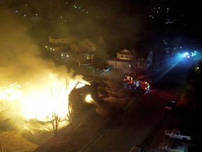Firefighters extinguish fire from a burning house in Superior, Boulder County, Colorado, U.S. December 30, 2021 in this still image obtained January 1, 2022 from a video shot with a drone.