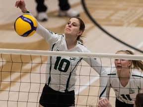Saskatchewan Huskies' middle Mandi Fraser (10) spikes the ball during a Canada West women's volleyball game against the University of Regina Cougars in Saskatoon, SK on Friday, February 11, 2022.