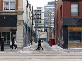 People walk through downtown Saskatoon on Monday, Feb. 14, 2022.