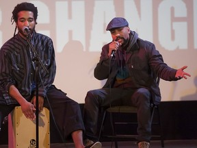 Spoken word poet Khodi Dill, right, along with a member of the group Magik Raddix, performs at the Roxy Theater during Voices for Change, Wednesday, March 19, 2014.