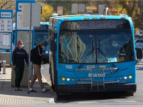 Masked transit users board a bus at the downtown bus mall. Photo taken in Saskatoon on Friday, Sept. 24, 2021.