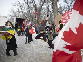 REGINA, SASK : February 5, 2022-- Protesters wave at oncoming vehicles alongside Alberts street and 20th avenue on Saturday, February 5, 2022 in Regina. KAYLE NEIS / Regina Leader-Post