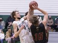 Holy Cross Crusaders forward Reese Kraft (#4) gets the block on Centennial Chargers centre Spencer Mayerle (#15) in high school boys basketball action on Friday, Feb 11, 2022. Holy Cross defeated Centennial 85-36. Photo by Colin Chatfield.