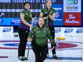 Saskatchewan skip Penny Barker reacts to a rock as Prince Edward Island's lead Michelle McQuaid, left, and second Meaghan Hughes look on at the Scotties Tournament of Hearts in Thunder Bay, Ont., on Tuesday.