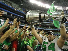 Saskatchewan Roughriders Jeremy O'Day holds up the Grey Cup after they defeated the Winnipeg Blue Bombers to win 23 to 19 at the Canadian Football League's 95th Grey Cup in 2007.
