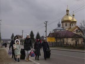 People walk the last few kilometres to the border with Poland on March 04, 2022 in Shehyni, Ukraine.