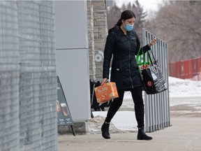 Masked customers exit Sobey's with their groceries on the last day that masks will be required while shopping. Photo taken in Saskatoon, Sask. on Monday, February 28, 2022.