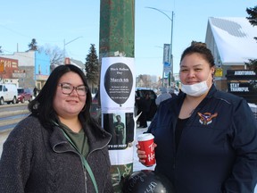 Shelby LaRose, left and Cree Crain, right, helped hang balloons and posters commemorating lives lost to overdose on 20th St. W in Saskatoon on Sunday, March 6.