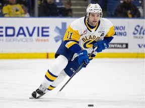 Saskatoon Blades' Tristen Robins takes on the Prince Albert Raiders at SaskTel Centre. Photo taken in Saskatoon, Sask. on Saturday, March 12, 2022.