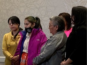Kyla Frenchman, in fuchsia jacket, is surrounded by supporters at Friday's media conference. She is calling for justice for her son, 13-month-old Tanner Brass.