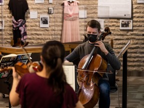 Scott McKnight, right, rehearses with the Amati cello on April 18, 2022.