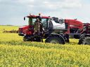 A farmer sprays a canola crop south of Regina.