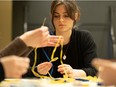 Sofia Fayfruk is one of five youth who met up in the St. George Cathedral basement to continue making blue and yellow bracelets which are being sold to raise money for people fleeing Ukraine. Photo taken in Saskatoon, Sask. on Friday, March 25, 2022.