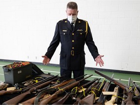 Saskatoon Police Chief Troy Cooper displays firearms that were voluntary turned in by members of the public, after announcing the results of the 2022 provincial gun amnesty program at Saskatoon police headquarters.