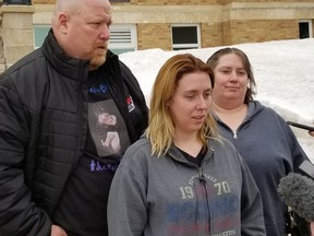 Heather Lynn Sumners (centre) speaks to reporters in front of Prince Albert Court of Queen's bench, flanked by her parents Corey (left) and Rhonda (right) Ferchoff prior to the sentencing of Nathaniel Carrier on Wednesday, April 13, 2022 (Jason Kerr / Prince Albert Daily Herald)