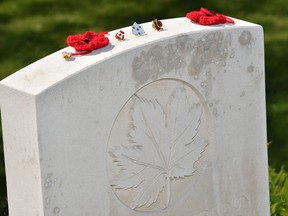 A picture shows objects placed on a grave in the Canadian military cemetery in Vimy, near Arras, northern France, on April 9, 2017.