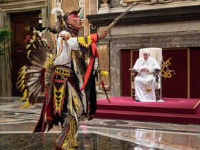 A member of Canada's Indigenous delegation chants and dances before Pope Francis during an audience at the Vatican on Friday. VATICAN MEDIA ORG XMIT: POS2022040111455870691620590