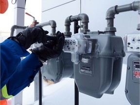 A file photo of a SaskEnergy worker installing a new gas meter in 2013.