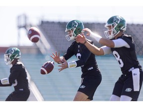 Roughrider quarterbacks (from left) Troy Williams, Jake Dolegala and Mason Fine run drills during the first day of Saskatchewan Roughriders rookie training camp at Griffiths Stadium.