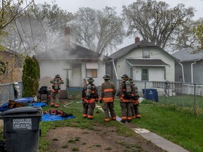 Firefighters respond to a house fire on the 200 block of Avenue H South on Friday, May 13, 2022.